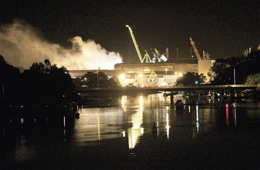 Smoke rises from a dry dock as fire crews respond Wednesday, May 23, 2012 to a fire on the USS Miami SSN 755 submarine at the Portsmouth Naval Shipyard on an island in Kittery, Maine. Four people were injured. (AP Photo/The Herald, Ionna Raptis)