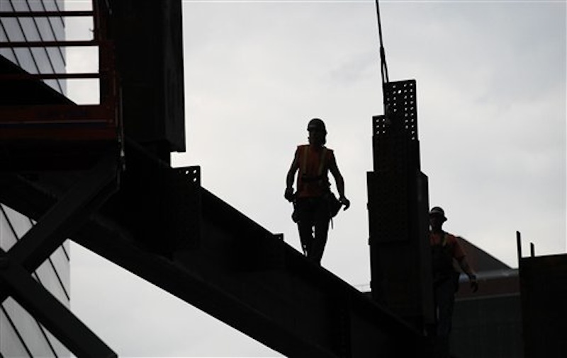 An ironworker walks a beam at Three World Trade Center, Monday, June 25, 2012 in New York. The 72-floor, 977-foot tower is scheduled to open late next year. It's expected to be the first tower completed on the 16-acre site since the 9/11 attacks. (AP Photo/Mark Lennihan) Silverstein;9/11;Sept 11;ground zero