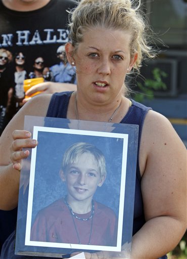FILE - In this Wednesday, Oct. 14, 2009 file photo, Malissa Durkee holds a framed photo of her brother Michael Brewer as she talks to a reporter in Deerfield Beach, Fla. Five teenagers were charged with aggravated battery for dousing the 15-year-old Brewer with rubbing alcohol and setting him on fire because he stopped someone from stealing his father's bicycle, authorities said. Michael Brewer was hospitalized with burns on more than three-quarters of his body after the attack at a Deerfield Beach apartment complex in October 2009. Jury selection in the trial of Matthew �Zeke� Bent, who faces attempted murder charges that carry a potential 30-year prison sentence because a weapon was used, is set begin June 11, 2012. He has pleaded not guilty. (AP Photo/Alan Diaz, File)