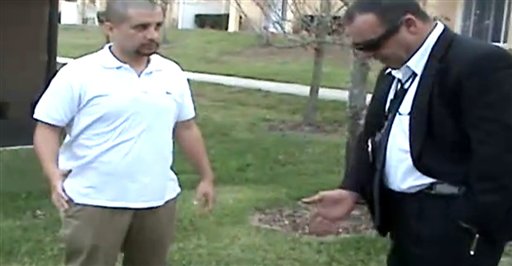 In this image from a Sanford Police video posted on a website called gzlegalcase.com by George Zimmerman's defense team, Zimmerman speaks to an unidentified investigator at the scene of Trayvon Martin's fatal shooting a day later, giving police a blow-by-blow account of his fight with the teen.