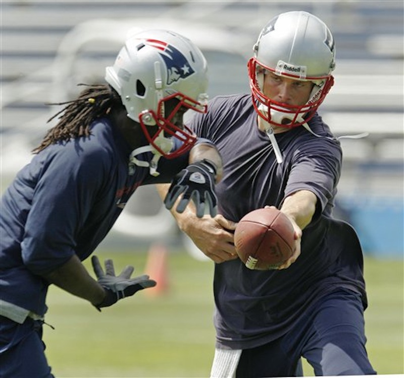 New England Patriots quarterback Tom Brady hands off to running back Joseph Addai during an NFL football team workout in Foxborough, Mass., Thursday, May 24, 2012. (AP Photo/Charles Krupa)