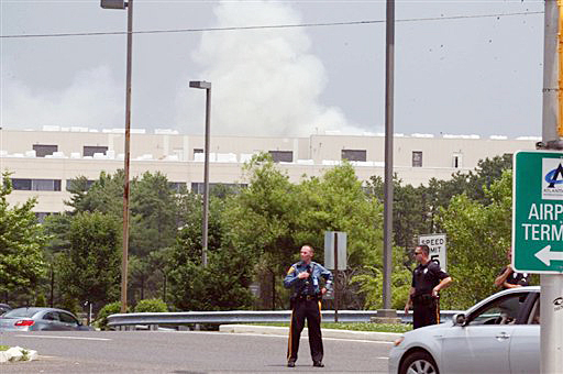 Police block off access to the Federal Aviation Administration's William J. Hughes Technical Center, in Egg Harbor Township, N.J., during a fire on Friday. The FAA says the fire at the building at Atlantic City International Airport made some traffic flow systems unavailable. The agency says those functions were transferred to a backup system.