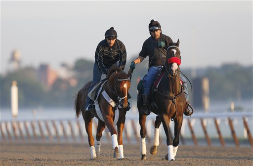 I'll Have Another, left, with exercise rider Jonny Garcia, accompanied by stablemate Lava Man, trains at Belmont Park today in Elmont, N.Y. The Triple Crown hopeful was to run Saturday in the Belmont Stakes.
