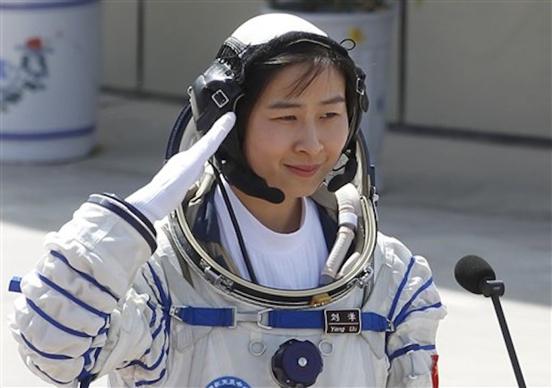 China's first female astronaut Liu Yang salutes during a sending off ceremony as she departs for the Shenzhou 9 spacecraft rocket launch pad at the Jiuquan Satellite Launch Center in Jiuquan, China, Saturday, June 16, 2012. China will send its first woman and two other astronauts into space Saturday to work on a temporary space station for about a week, in a key step toward becoming only the third nation to set up a permanent base in orbit.(AP Photo/Ng Han Guan)
