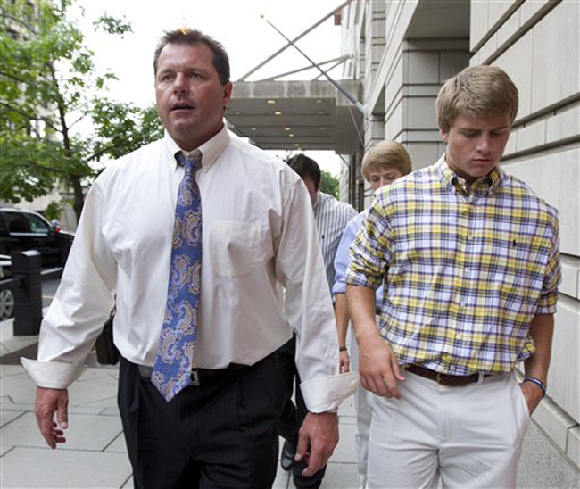 Former Major League Baseball pitcher Roger Clemens, left, leaves federal court in Washington with son Kacy on Tuesday.