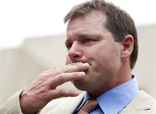 Former Major League Baseball pitcher Roger Clemens holds back tears as he talks to the media outside federal court in Washington on Monday, after his acquittal on charges of lying to Congress in 2008.