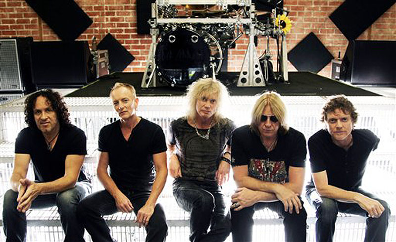 This May 31, 2012 photo shows, from left, Vivian Campbell, Phil Collen, Rick Savage, Joe Elliott, and Rick Allen, of musical group Def Leppard in Los Angeles. The band re-recorded two of their songs that appear in the film, "Rock of Ages"and they're teaming up with Poison and Lita Ford for a summer tour kicking off June 20 in Salt Lake City, Utah. (Photo by Matt Sayles/Invision/AP) Portrait