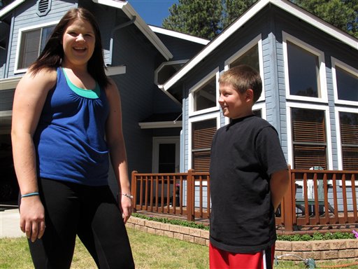 Colleen Knaggs, 18, talks about her fruitless efforts to find a summer job, from her home in Flagstaff, Ariz., recently. Instead, Knaggs will be babysitting her 10-year-old brother, Matthew Knaggs, right.
