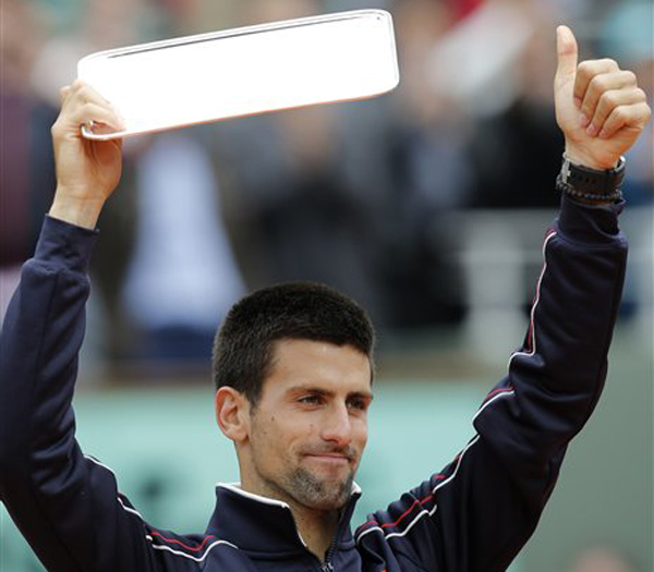 Novak Djokovic of Serbia holds the second place trophy after losing to Rafael Nadal of Spain at the French Open today.