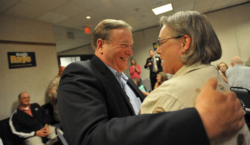 Staff photo by Michael G. Seamans Kevin Raye, candidate for US second congressional district, greets supporter Gail Kelly at the Ramada Inn in Bangor Tuesday night.