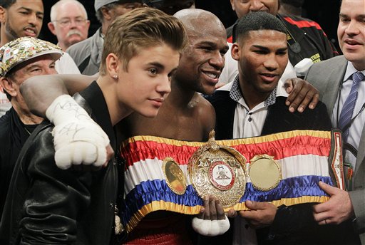 Floyd Mayweather Jr., center, poses for a photo with Justin Bieber and Yuriyorkis Gamboa after defeating Miguel Cotto for the WBA super welterweight title, on May 5, 2012, in Las Vegas.