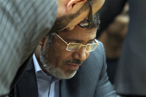 Muslim Brotherhood presidential candidate Mohammed Morsi confers with an aide recently during a meeting with relatives of those killed and injured during last year's revolution.