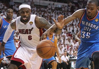 LeBron James battles for a lose ball with Kevin Durant during the third quarter of game 5 of the NBA Finals between the Oklahoma City Thunder against Miami Heat on Thursday.