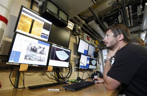 Survey tech David Moehl looks over data during a test of a new side scan sonar system aboard the Ferdinand R. Hassler in Norfolk, Va. The federal research vessel that will help update nautical charts on the East Coast will be commissioned on Friday.