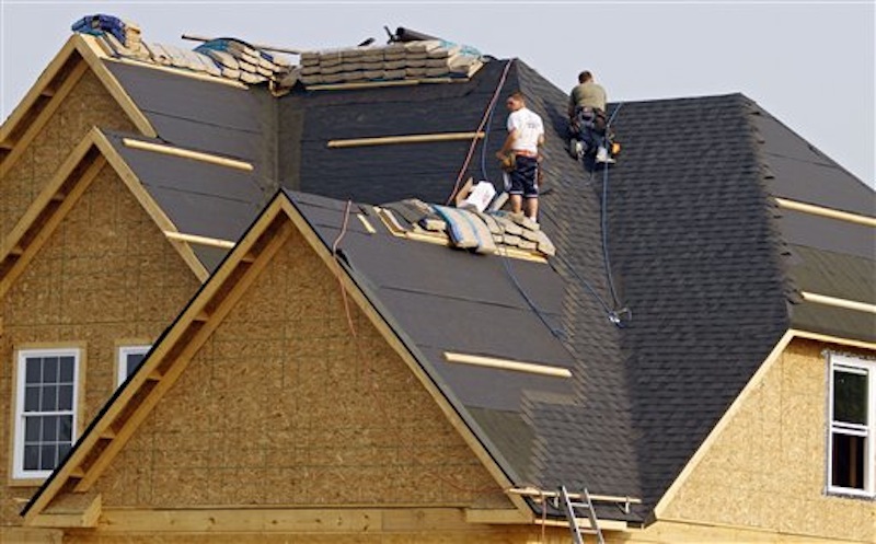 In this Friday, May 25, 2012, file photo, roofers shingle a new home under construction in Columbia Station, Ohio Friday, May 25, 2012. Americans bought new homes in May at the fastest pace in more than two years. The increase suggests a modest recovery in the housing market continues, despite weaker job growth. The Commerce Department says that sales of new homes increased 7.6 percent in May from April to a seasonally adjusted annual rate of 369,000 homes. (AP Photo/Mark Duncan)