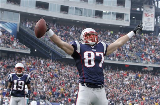 New England Patriots tight end Rob Gronkowski celebrates his touchdown reception in front of wide receiver Brandon Tate (19) in the first quarter of an NFL football game against the Miami Dolphins in Foxborough, Mass., in this Jan 2, 2011, photo.
