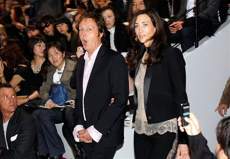 In this Monday, Oct. 5, 2009 file photo, British musician Paul McCartney, and his companion Nancy Shevell arrive for the presentation of his daughter British fashion designer Stella McCartney's Ready to Wear Spring Summer 2010 fashion collection, in Paris. McCartney turned 70 years of age Monday June 18, 2012. (AP Photo/Christophe Ena, File)