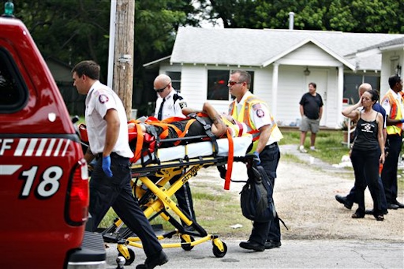 A person reportedly injured by Anthony Giancola is wheeled to a waiting ambulance, in Lealman, Fla., Friday, June 22, 2012. Authorities said Giancola, an ex-Tampa Bay-area middle school principal who lost his job over a drug arrest five years ago, went on a rampage Friday, stabbing several people, killing at least two. Authorities said there were 11 victims in all, and several are being treated at area hospitals for injuries ranging from minor to life-threatening. (AP Photo/Tampa Bay Times, Melissa Lyttle)