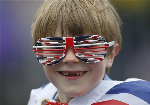 Owen Lewis, 7, is among thousands of people gathering along the river Thames in London waiting for Britain's Queen Elizabeth II flotilla of boats to sail past.