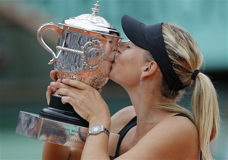 Maria Sharapova of Russia kisses the trophy after winning the women's final match against Sara Errani of Italy at the French Open tennis tournament in Roland Garros stadium in Paris, Saturday June 9, 2012. Sharapova won in two sets 6-3, 6-2. (AP Photo/Christophe Ena)