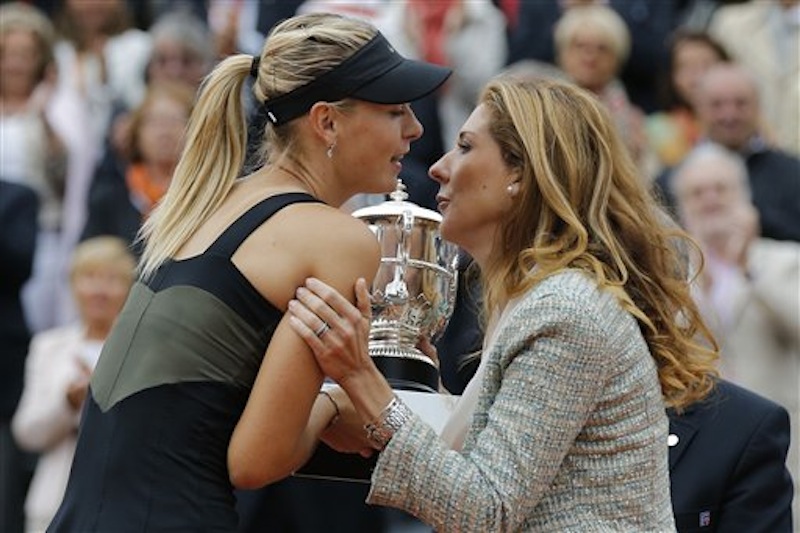 Three-time French Open winner Monica Seles of the U.S., right, congratulates Maria Sharapova of Russia who won the women's final match against Sara Errani of Italy at the French Open tennis tournament in Roland Garros stadium in Paris, Saturday June 9, 2012. Sharapova won in two sets 6-3, 6-2. (AP Photo/Michel Euler)