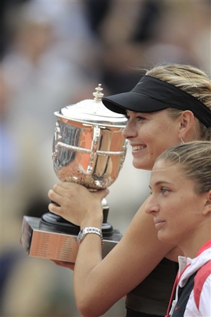 Maria Sharapova of Russia, rear, holds the trophy after winning the women's final match against Sara Errani of Italy, right, at the French Open tennis tournament in Roland Garros stadium in Paris, Saturday June 9, 2012. Sharapova won in two sets 6-3, 6-2. (AP Photo/Bernat Armangue)
