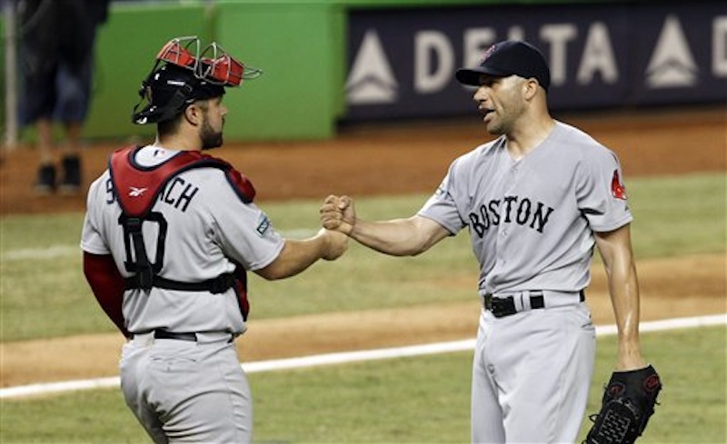Boston Red Sox relief pitcher Alfredo Aceves, right, is congratulated by catcher Kelly Shoppach after Boston's 2-1 win against the Miami Marlins during an interleague baseball game in Miami, Tuesday, June 12, 2012. (AP Photo/Alan Diaz)