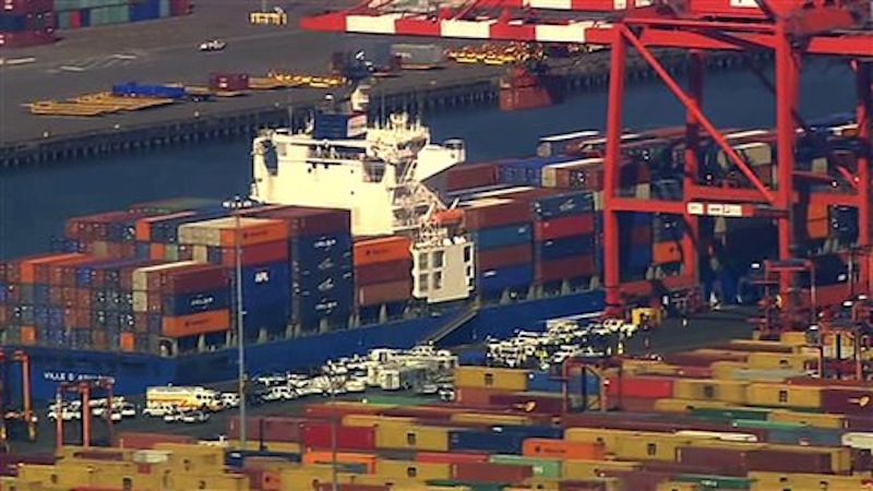 This image made from video provided by Eyewitness News WABC-TV shows an aerial view of a container ship in Newark with suspected stowaways. Dock workers rushed to unload containers stacked on top of one another inside a cargo ship that arrived in New Jersey from the Middle East on Wednesday, June 27, 2012 after Coast Guard officials heard knocking from one during a routine inspection, suggesting that stowaways might be on board. (AP Photo/Eyewitness News WABC-TV) MANDATORY CREDIT