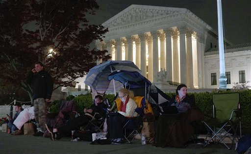 People wait in line in front of the Supreme Court in Washington, D.C., on March 25, the eve of oral arguments before the court on President Obama's health care legislation.
