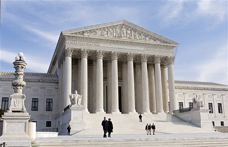 This Jan. 25, 2012 file photo shows the Supreme Court Building in Washington. The Supreme Court has ruled that the 90,000 sales representatives for pharmaceutical companies do not qualify for overtime pay under federal law, a major victory for the drug industry. (AP Photo/J. Scott Applewhite, File)