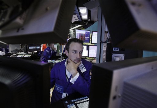 FILE - In this June 1, 2012 file photo, Specialist Christopher Trotta is framed by screens as he works at his post on the floor of the New York Stock Exchange. U.S. stock futures are rebounding Monday, June 4, 2012, from a 275-point plunge Friday even with markets in Europe and Asia slumping. (AP Photo/Richard Drew, File)