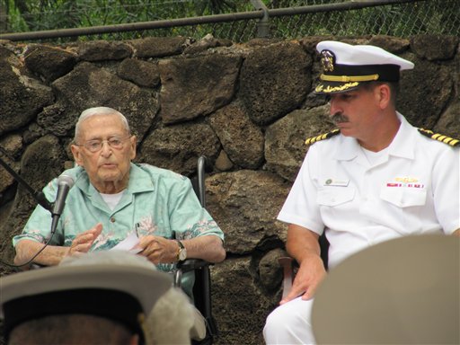 In this photo taken June 1, 2012, retired Rear Adm. Mac Showers, left, the last surviving member of the intelligence team that deciphered Japanese messages in the lead up to the Battle of Midway, speaks during a ceremony in Pearl Harbor, Hawaii. Listening at right is Capt. James Fannell, the Pacific Fleet's deputy chief of staff for intelligence. On Monday, June 4, 2012, Showers and Navy officials are observing the 70th anniversary of the battle that changed the course of World War II. (AP Photo/Audrey McAvoy)