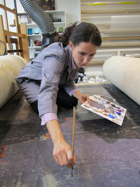 A Williamstown Art Conservation Center conservator touches up scenes from a 161-year-old panorama of Pilgrim's Progress. Flasche Vinylic colors were used for the touch-up work as they dry matte to match the original finish. The restored panorama, property of the Saco Museum, will be exhibited from June 30 to Nov. 10 at venues in Biddeford and Saco.