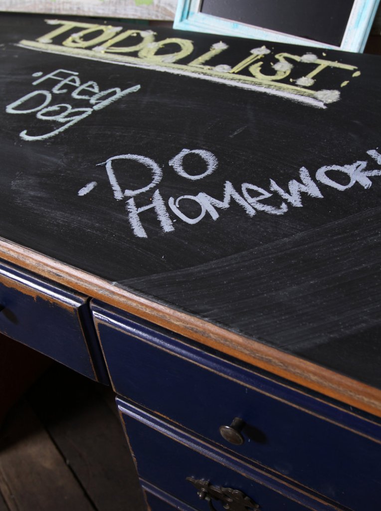 Chalkboard paint transformed this desktop into into an erasable writing surface, perfect for a to-do list. Black – as in blackboard – is the most typical color of chalkboard paint, but it can be any color.