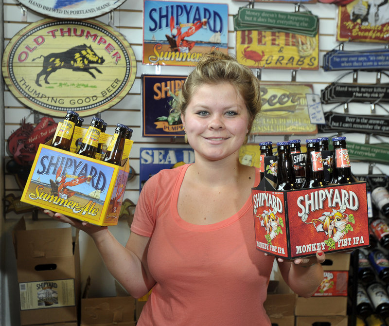 Retail associate Katya Dolloff shows off Summer Ale and Monkey Fist IPA at Shipyard in Portland, voted Best Brewery.