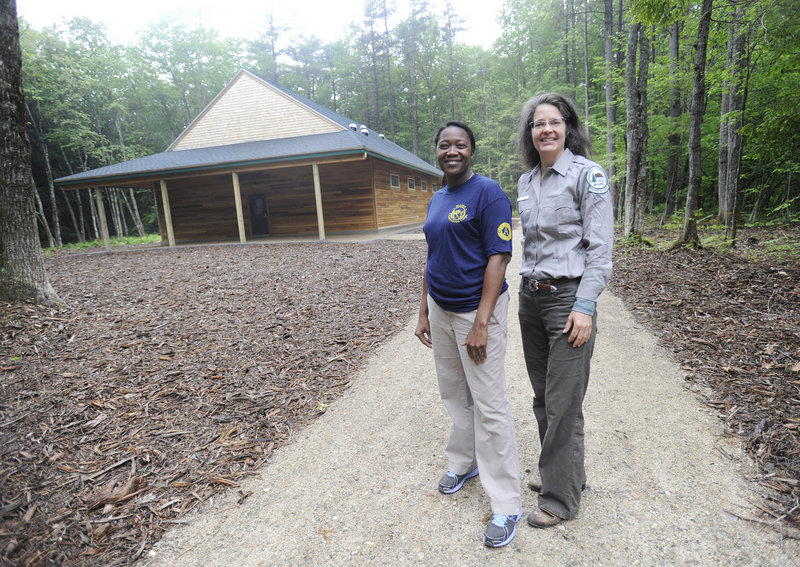 Lisha Wedderburn, left, an environmental educator with the Maine Conservation Corps, and Jocelyn Hubbell, interpretive specialist with the Maine Bureau of Parks and Lands stand outside the new nature center.