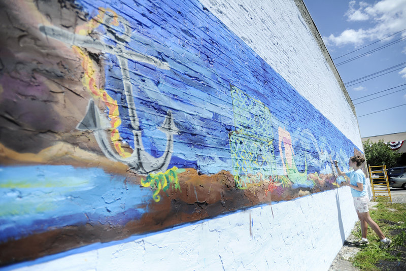 Noelle Webster, a Cape Elizabeth High School senior, paints a mural on the exterior wall of The 50’s Pub in downtown Biddeford Thursday. Webster, who is planning to attend Rhode Island School of Design in the fall, is creating the mural as part of a graduation service requirement.
