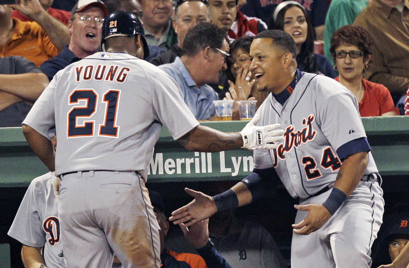 Delmon Young gets congratulated by Miguel Cabrera after a solo home run in the eighth inning Thursday night in Boston. The Tigers won 7-3 to avoid a four-game sweep.