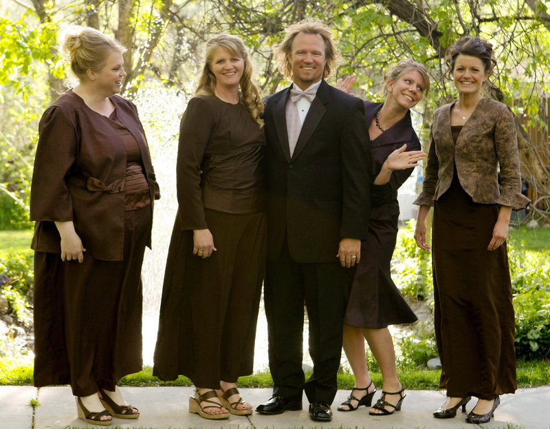 Kody Brown poses with his wives, from left, Janelle, Christine, Meri, and Robyn, in a promotional photo for TLC’s reality TV show, “Sister Wives.” The family includes 16 children.