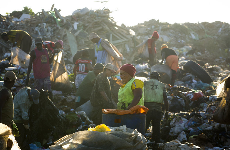 Trash pickers, or “catadores,” collect recyclable materials May 29 at Jardim Gramacho in Rio de Janeiro, Brazil. They will receive a lump-sum payout from the city, but there’s no place for them at the new high-tech dump.