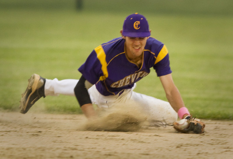 Cheverus shortstop Louie DiStasio makes a diving stab of a ground ball during the Telegram League championship game Friday night against Windham. Cheverus won, 10-8.