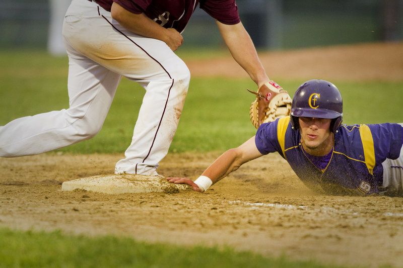 Nick Melville of Cheverus dives back to first base ahead of the tag by Windham’s Robbie Hamilton. Cheverus claimed the Telegram League baseball title with a pair of wins Friday – 3-2 over Marshwood in eight innings, and 10-8 over Windham.