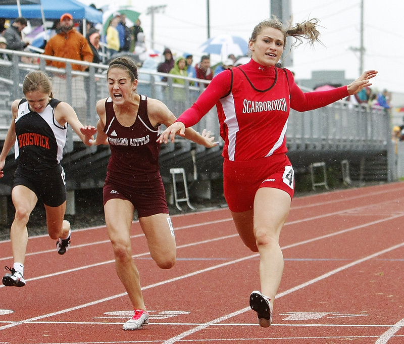 Nicole Kirk of Scarborough zips through the rain Saturday to win the 100 meters in 12.25 seconds in the Class A outdoor track and field state championships Saturday at Windham High. Kirk also came away with a victory in the 200.
