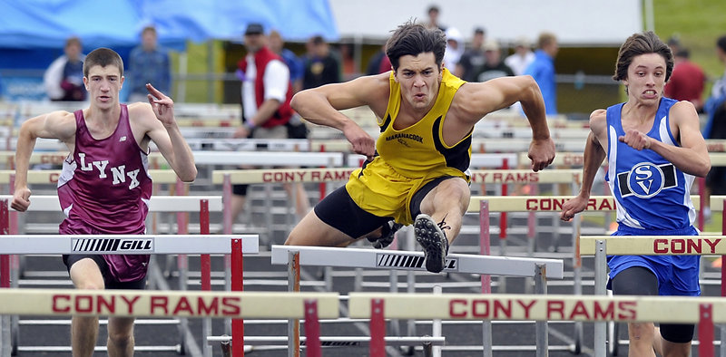 Taylor Watson of Maranacook handles a hurdle Saturday on the way to winning the 110-meter hurdles in 15.83 seconds at the Class C state meet at Augusta. Kenny Bouchey, right, of Sacopee Valley was second and Isaac Ocana, left, of Mattanawcook Academy was fourth.
