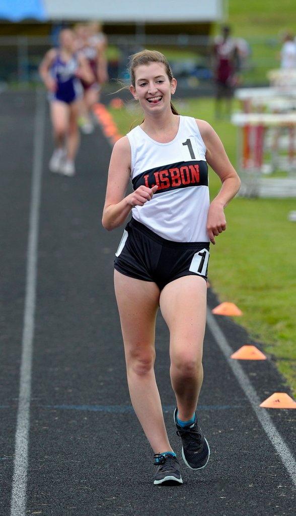 Lindsey Whitney of Lisbon is all smiles while easily winning the 1,600 racewalk in a time of 8 minutes, 20.8 seconds – almost 15 seconds in front.