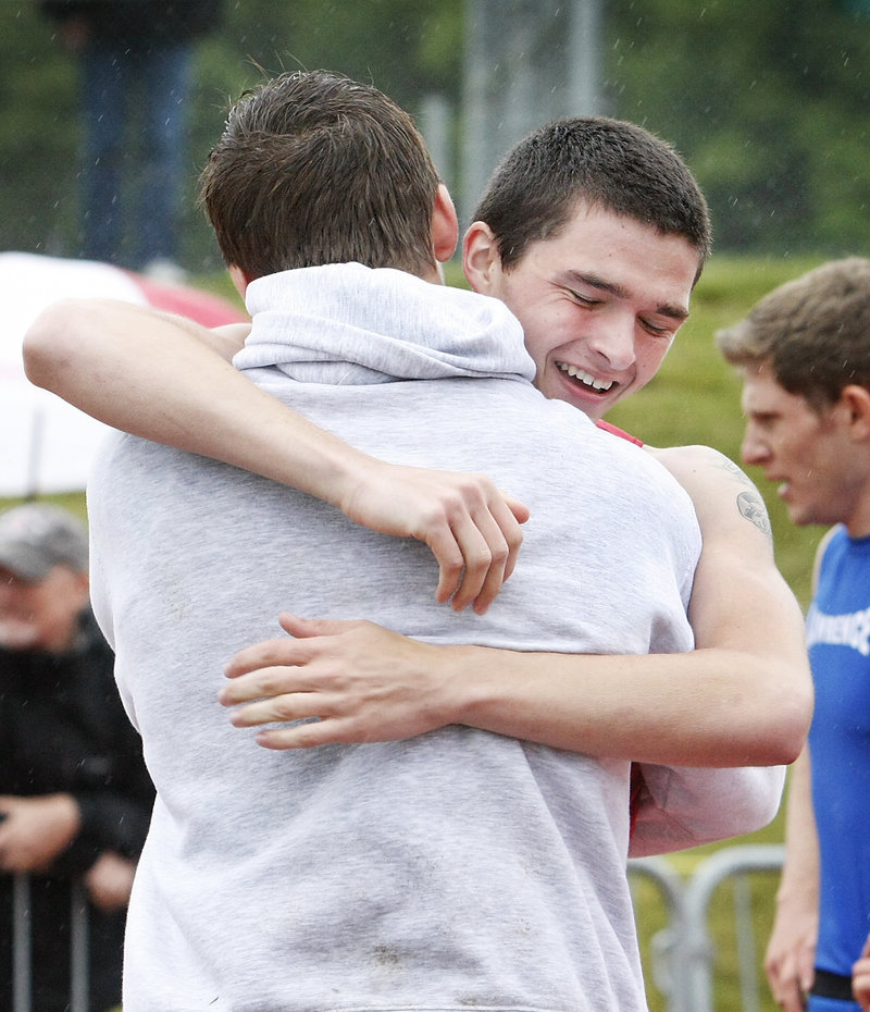 Dan Webb of Sanford receives a hug after capturing the 400 in 49.93 seconds. Sanford hopes to win its first outdoor track state title.