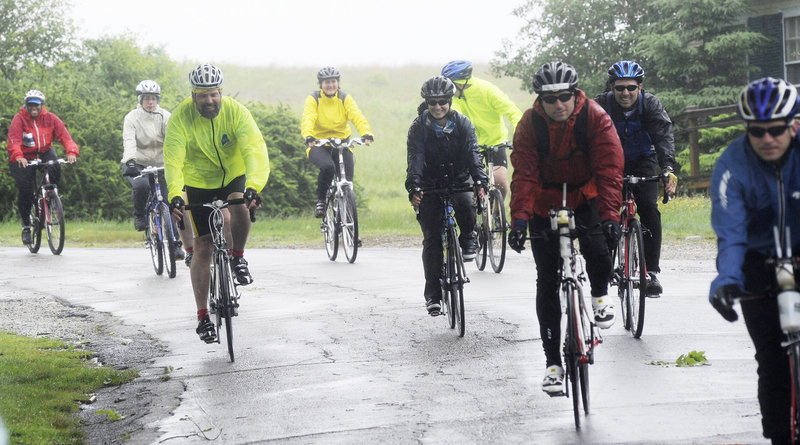 Bikers head out from Wells Reserve at Laudholm Farm for a ride that took place in record-setting rain that forced cancellation of the longest route, 100 miles, for safety reasons.