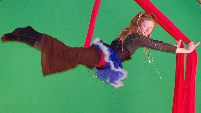 Jenn Bliss, aka Miss Bliss, uses fabric hung from the ceiling as a flying apparatus.