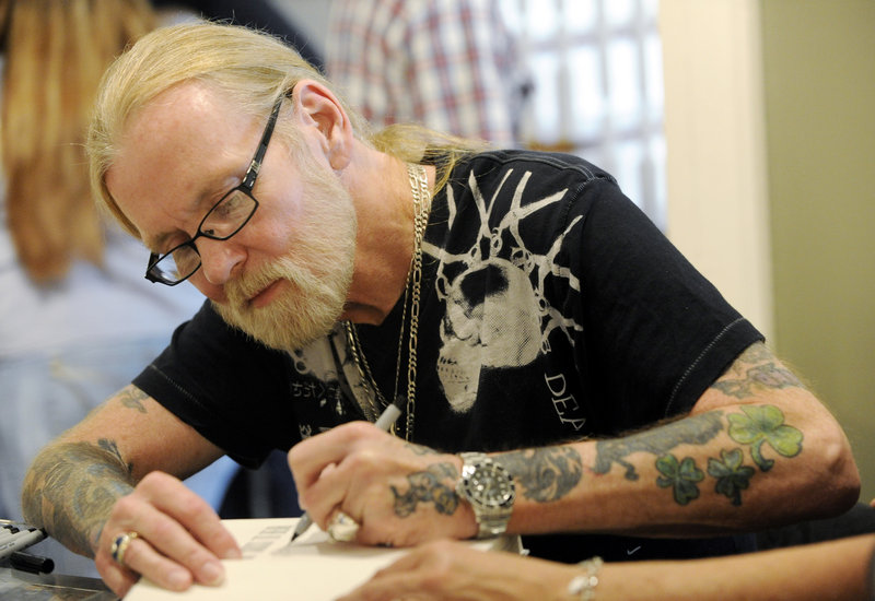 Gregg Allman signs copies of his book “My Cross to Bear” in Macon, Ga., on Sunday.