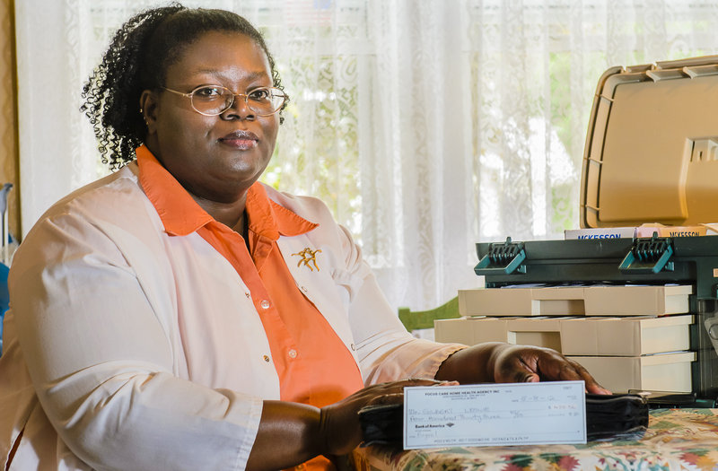 Leslie Gilbert of Grand Rapids, Mich., a former employee of Focus Care Home Health, displays the check she received for back wages. The check was not signed and for the incorrect amount and had to be returned.